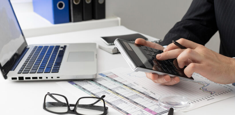 side-view-business-man-calculating-finance-numbers